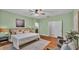 Comfortable bedroom with hardwood floors, a ceiling fan, and a connected bathroom at 1073 Vinsetta Cir, Winter Garden, FL 34787