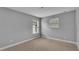 Neutral bedroom with carpet, baseboards, and two windows at 1073 Vinsetta Cir, Winter Garden, FL 34787