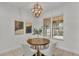 Breakfast nook featuring a round table, chairs, contemporary chandelier, and view to outdoor lanai at 1073 Vinsetta Cir, Winter Garden, FL 34787