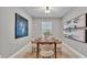 Dining room with a wooden table set for six, neutral chairs, and bright natural light at 1073 Vinsetta Cir, Winter Garden, FL 34787