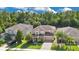 Inviting two-story home boasts a well-manicured lawn, elegant brick driveway, and mature trees at 1073 Vinsetta Cir, Winter Garden, FL 34787