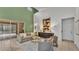 Bright living room with high ceilings, stylish furniture, and sliding glass doors at 1073 Vinsetta Cir, Winter Garden, FL 34787