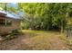 Expansive backyard with lush greenery, mature trees, and fencing offers privacy and space to roam at 11 Se 31St St, Ocala, FL 34471