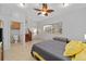 Bedroom with tile floor, ceiling fan, and adjacent bathroom and stair access to the main house at 11 Se 31St St, Ocala, FL 34471