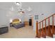 Studio with bed, kitchenette, ceiling fan, and staircase leading to the upper level at 11 Se 31St St, Ocala, FL 34471