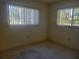 Bright bedroom with carpet flooring and natural light from two windows at 11255 Sw 76Th Ter, Ocala, FL 34476