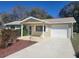 Charming single-story home with a welcoming front porch and attached one-car garage with a long driveway at 11255 Sw 76Th Ter, Ocala, FL 34476
