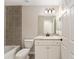 Bathroom with vanity, decorative mirror and tiled shower at 114 Bay Dr, Ocklawaha, FL 32179