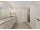 Bright bathroom features double sinks with granite counters, sleek white cabinets, and a tiled walk-in shower at 114 Bay Dr, Ocklawaha, FL 32179