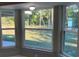 Sunlit bay window offering panoramic views of the lush backyard landscaping at 114 Bay Dr, Ocklawaha, FL 32179