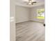 The neutral bedroom has a ceiling fan and a view of the outdoors at 114 Bay Dr, Ocklawaha, FL 32179