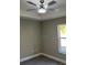 Cozy bedroom with a tray ceiling, modern ceiling fan, wood-look flooring, and a window with natural light at 114 Bay Dr, Ocklawaha, FL 32179