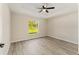 Bright bedroom features a ceiling fan and a view of the outdoors at 114 Bay Dr, Ocklawaha, FL 32179