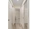 Hallway with plank floors and white doors to other rooms at 114 Bay Dr, Ocklawaha, FL 32179