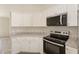 Kitchen with white cabinets, granite countertops, and stainless-steel appliances at 114 Bay Dr, Ocklawaha, FL 32179