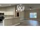 Bright kitchen with a breakfast bar, stainless appliances, and granite countertops seamlessly connected to the living area at 114 Bay Dr, Ocklawaha, FL 32179