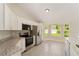 Bright kitchen features stainless appliances, white cabinets and granite countertops at 114 Bay Dr, Ocklawaha, FL 32179