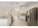 Open concept kitchen with stainless appliances, granite countertop and large bar at 114 Bay Dr, Ocklawaha, FL 32179
