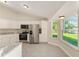 Bright kitchen with stainless appliances and white cabinets at 114 Bay Dr, Ocklawaha, FL 32179