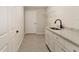 Laundry room offers a sink and countertop on white cabinets at 114 Bay Dr, Ocklawaha, FL 32179