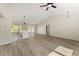 Open-concept living area showcases wood-look flooring, high ceilings, and seamless access to the kitchen and dining area at 114 Bay Dr, Ocklawaha, FL 32179