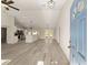 Open-concept living area showcases wood-look flooring, high ceilings, and seamless access to the kitchen, creating a welcoming atmosphere at 114 Bay Dr, Ocklawaha, FL 32179