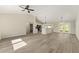 Bright open-concept living area with modern flooring, high ceilings, and seamless access to the kitchen at 114 Bay Dr, Ocklawaha, FL 32179