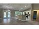 Open-concept living space with wood flooring, pendant lighting, and a kitchen island perfect for entertaining at 114 Bay Dr, Ocklawaha, FL 32179