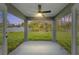 Covered outdoor patio with a ceiling fan, concrete flooring, and views of the private backyard and surrounding nature at 114 Bay Dr, Ocklawaha, FL 32179