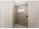 Tiled shower with a built-in window at 114 Bay Dr, Ocklawaha, FL 32179