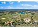 Vast aerial shot of a rural community featuring a picturesque lake and rolling fields at 12424 Sw 140Th Loop, Dunnellon, FL 34432