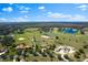 Extensive aerial view showing a serene community with ponds and equestrian facilities at 12424 Sw 140Th Loop, Dunnellon, FL 34432