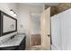 Elegant bathroom featuring a granite vanity, decorative mirror, and access to the shower/tub combo at 12424 Sw 140Th Loop, Dunnellon, FL 34432