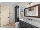 Classic bathroom with a granite vanity, large mirror, and a linen closet for ample storage at 12424 Sw 140Th Loop, Dunnellon, FL 34432