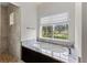 Bathroom featuring a soaking tub with granite, and a walk-in shower with natural stone surround at 12424 Sw 140Th Loop, Dunnellon, FL 34432