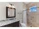 Bathroom features a granite vanity, large mirror, and tiled shower with a rainfall showerhead at 12424 Sw 140Th Loop, Dunnellon, FL 34432