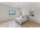 Bright bedroom with tiled floors, a queen bed, and large windows with views of the property at 12424 Sw 140Th Loop, Dunnellon, FL 34432