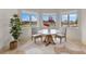 Bright breakfast nook with a round table, seating for two, and views of the surrounding landscape at 12424 Sw 140Th Loop, Dunnellon, FL 34432