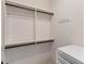 A walk-in closet features an adjustable shelving system and hardware for hanging clothes at 12424 Sw 140Th Loop, Dunnellon, FL 34432