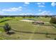 Outdoor horse arena with fencing and pond, set in a vast, green landscape at 12424 Sw 140Th Loop, Dunnellon, FL 34432