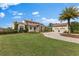 Elegant home featuring lush landscaping, a brick driveway, and a two-car garage at 12424 Sw 140Th Loop, Dunnellon, FL 34432