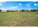 Green field with paddock and horse barn in the background at 12424 Sw 140Th Loop, Dunnellon, FL 34432