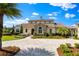Stunning two-story home with a stone accent, manicured lawn, and a circular driveway at 12424 Sw 140Th Loop, Dunnellon, FL 34432