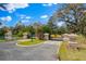 Elegant stone entrance gates with decorative sunbursts and lush landscaping at a residential community at 12424 Sw 140Th Loop, Dunnellon, FL 34432