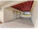 View of a horse barn aisle way featuring a brick-paved drive, stalls, and a glimpse of the surrounding property at 12424 Sw 140Th Loop, Dunnellon, FL 34432