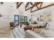Bright living room with high ceilings, wood beams, and sliding glass doors to the outdoor patio at 12424 Sw 140Th Loop, Dunnellon, FL 34432