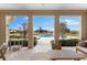 Covered outdoor living space overlooking a pool, beautiful landscaping, and a serene rural setting at 12424 Sw 140Th Loop, Dunnellon, FL 34432