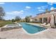 A luxurious backyard pool with a connected hot tub and elegant travertine stone work at 12424 Sw 140Th Loop, Dunnellon, FL 34432