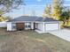 Well-maintained one-story residence with a contemporary color scheme, a two-car garage, and a lush lawn at 13384 Sw 105 Pl, Dunnellon, FL 34432
