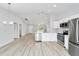 Contemporary kitchen with stainless steel appliances, sleek white cabinets, quartz countertops, and an open layout for entertaining at 13384 Sw 105 Pl, Dunnellon, FL 34432